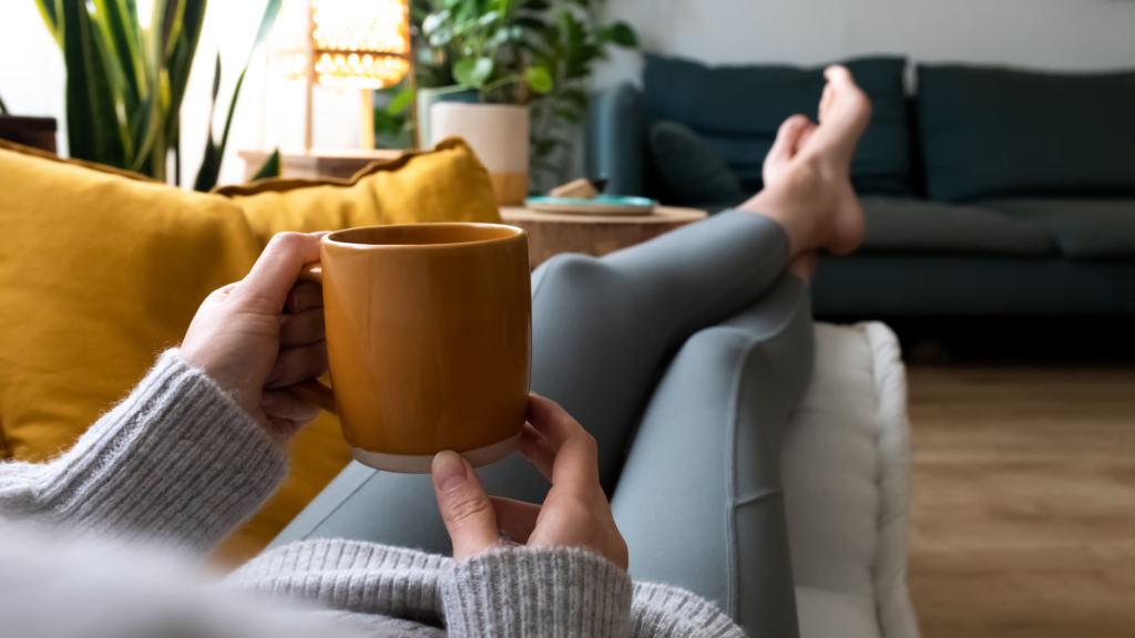 A lady on a sofa enjoying her coffee | Wellbeing Oasis