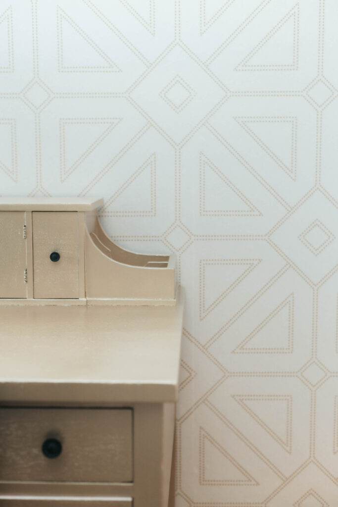 Wooden desk that complements the patterns on the wall